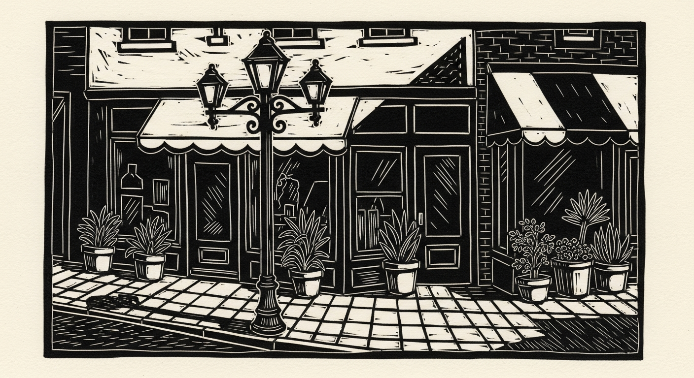 Linocut of small shops along brick sidewalk.